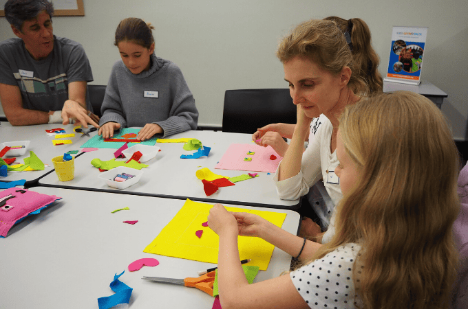 teaching a class of kids to sew