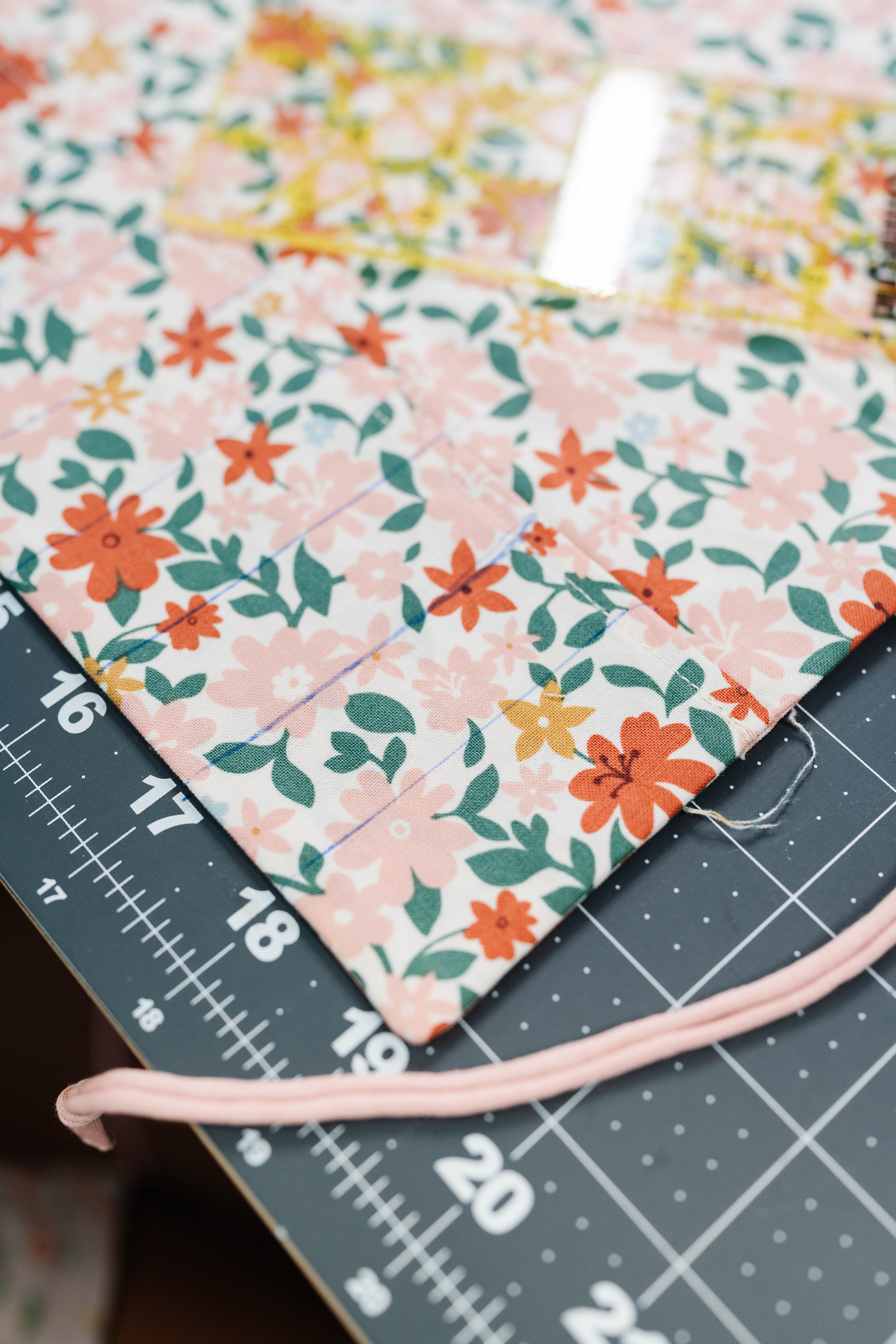 Happy Stitches sewing project supplies for a Crayon Wrap Roll, including fabric pieces, Clover Hot Ruler, Rotary Cutter, Heart-Shaped Pins, Wonder Clips, and Roll & Press